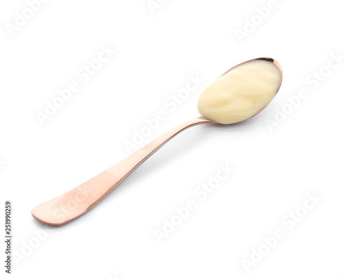 Spoon with tasty yogurt on white background photo