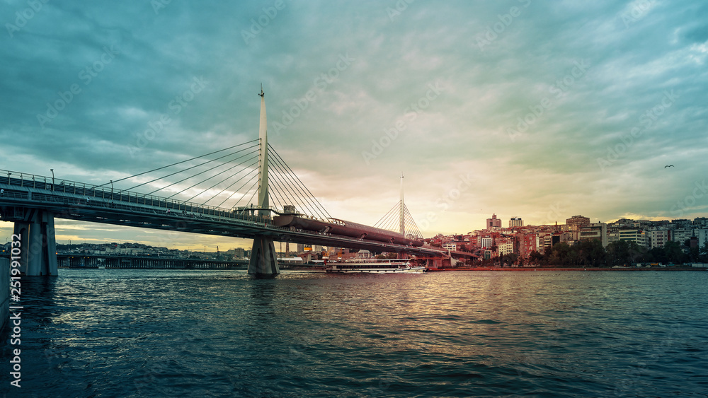Fototapeta premium View of Golden Horn Metro Bridge (Halic Bridge) at sunset. Istanbul, Turkey.