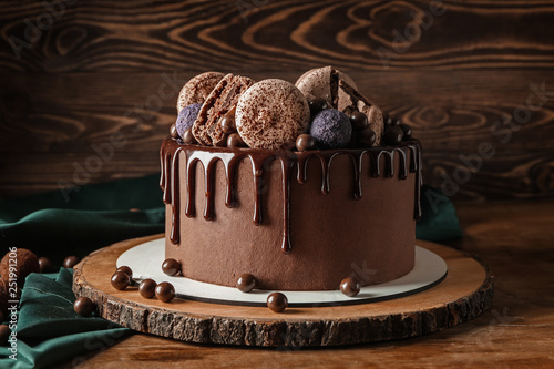 Sweet chocolate cake on wooden table photo
