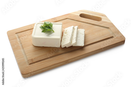 Board with tasty feta cheese on white background