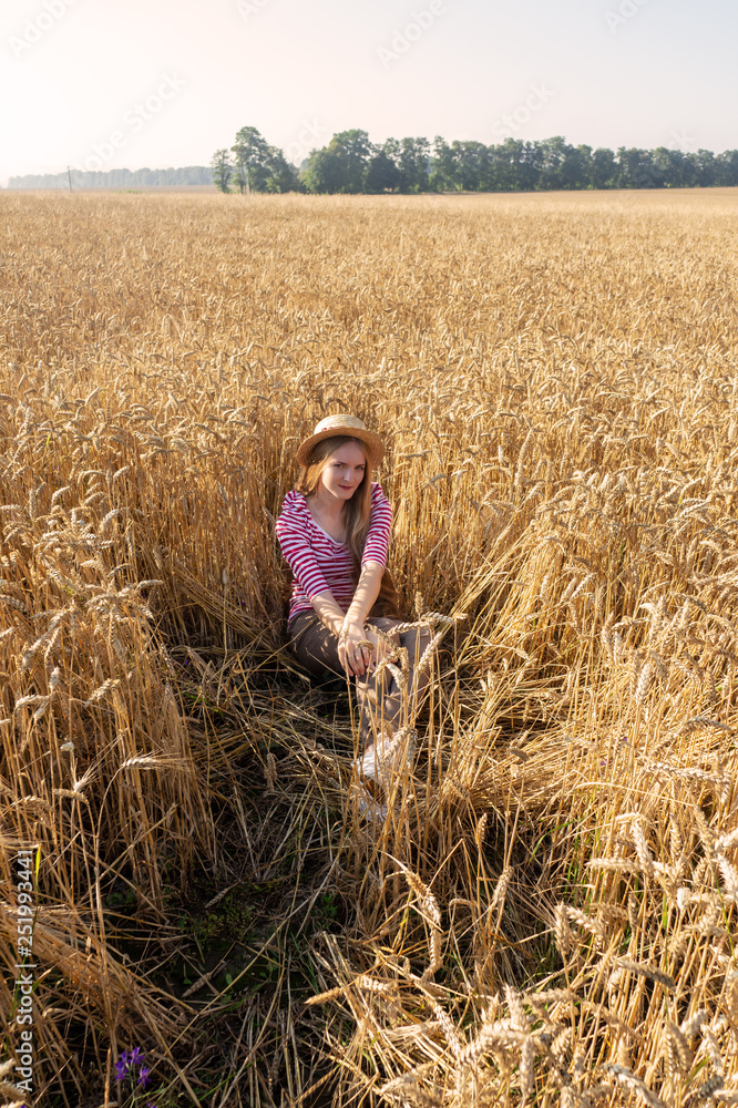 Portrait of a girl sitting in wheat. Portrait of a girl sitting in wheat.