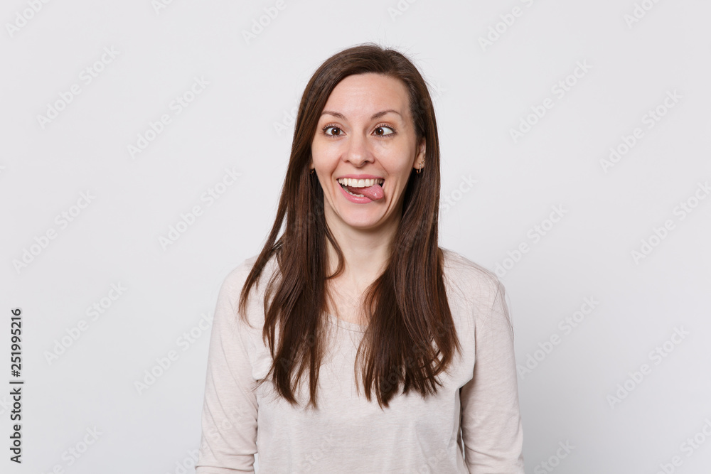 ?razy funny young woman with beveled eyes in light clothes showing tongue, fooling around isolated on white wall background in studio. People sincere emotions, lifestyle concept. Mock up copy space. ?razy funny young woman with beveled eyes in light clothes showing tongue, fooling around isolated on white wall background in studio. People sincere emotions, lifestyle concept. Mock up copy space.