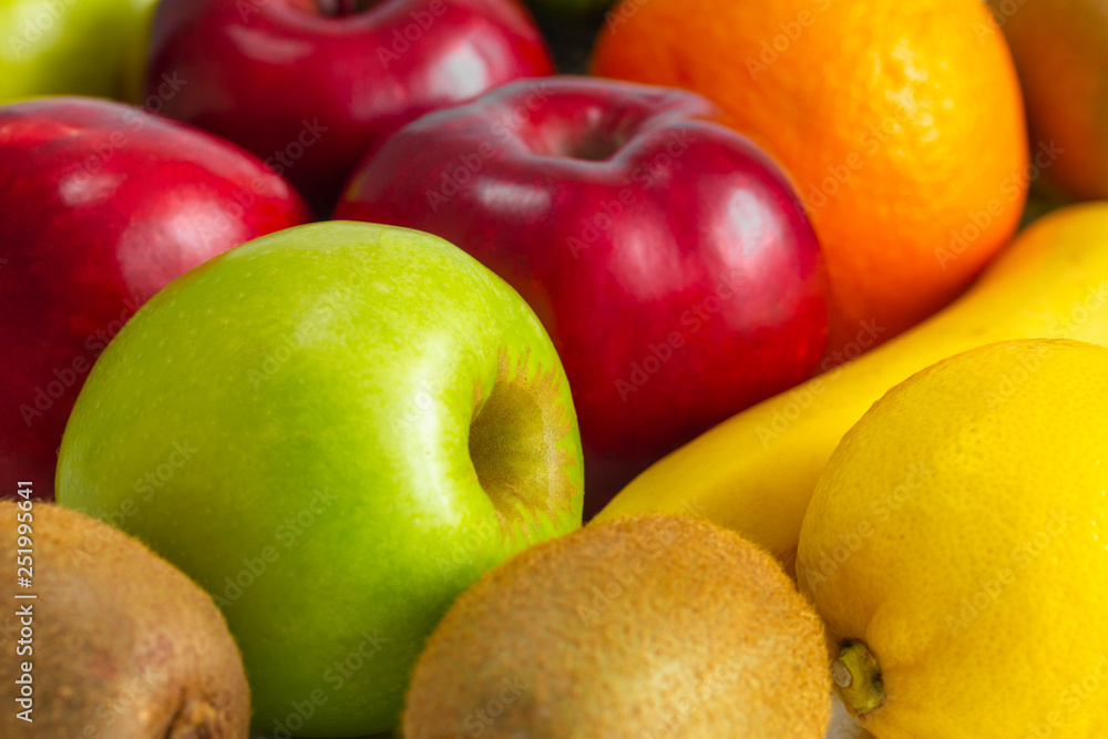 red green apples with ripe bananas and kiwi orange lemon on a white background red green apples with ripe bananas and kiwi orange lemon on a white background