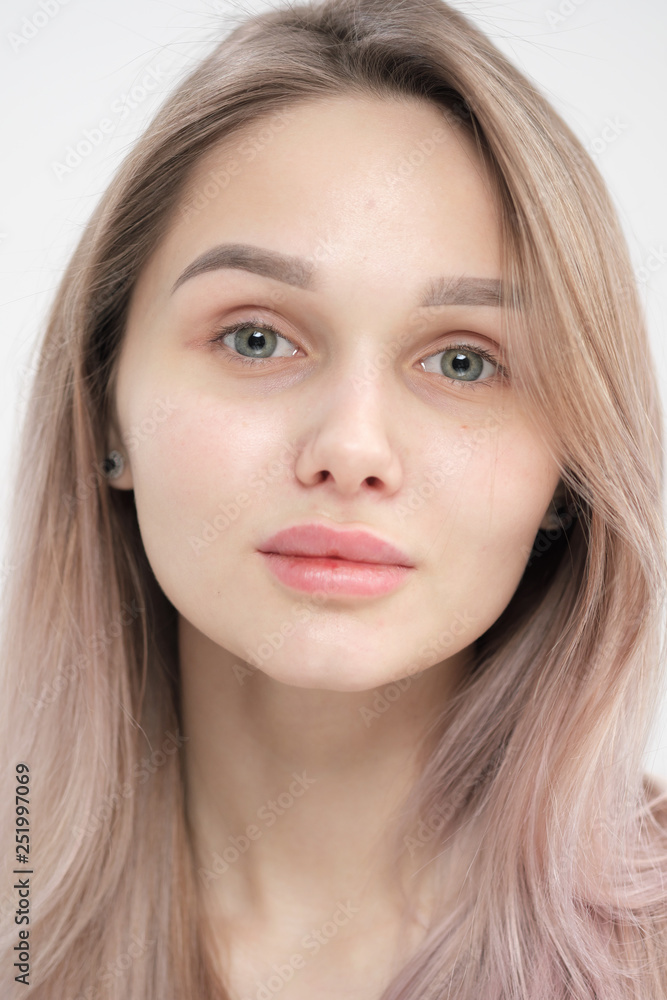Close-up of the face of a beautiful young blonde girl with smooth skin. Close-up of the face of a beautiful young blonde girl with smooth skin.