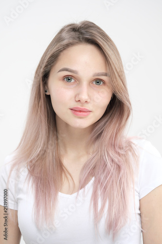 Close-up of the face of a beautiful young blonde girl with smooth skin.