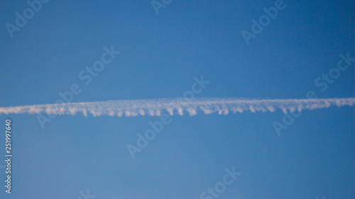 Trail after the plane in the sky. © Sergey