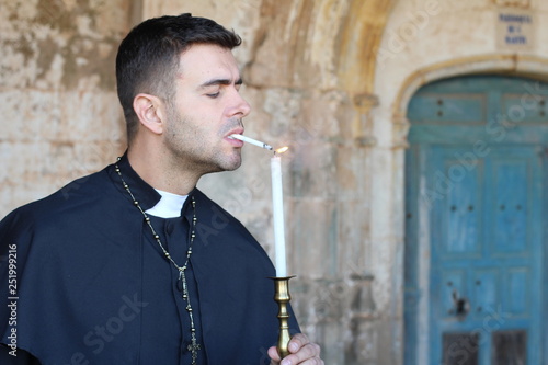 Photography Preacher with nicotine addiction lighting a cigarette