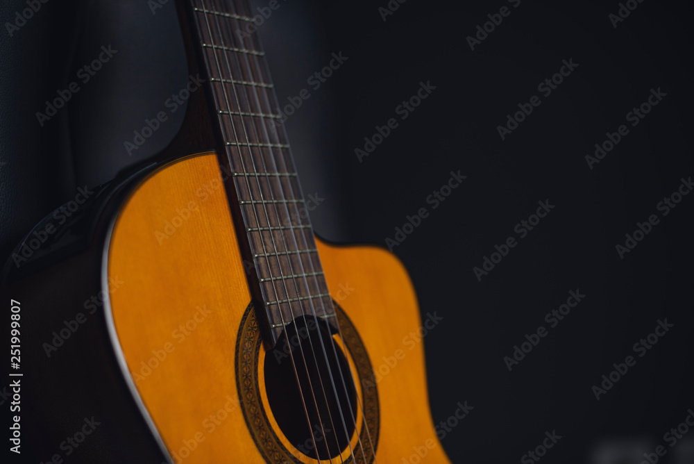 yellow guitar with black background