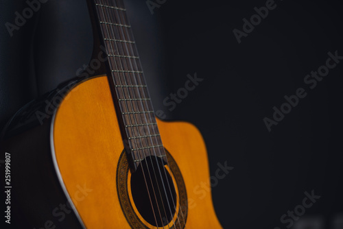 yellow guitar with black background