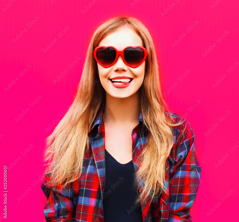 close-up portrait happy smiling blonde woman in heart shaped red sunglasses on colorful pink background close-up portrait happy smiling blonde woman in heart shaped red sunglasses on colorful pink background