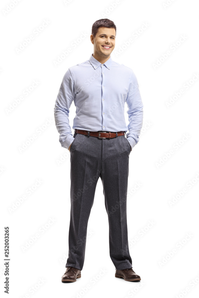 Young man in a shirt and trousers posing with hands in pocket Young man in a shirt and trousers posing with hands in pocket