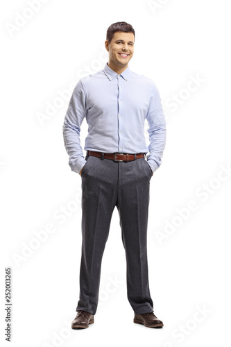 Young man in a shirt and trousers posing with hands in pocket