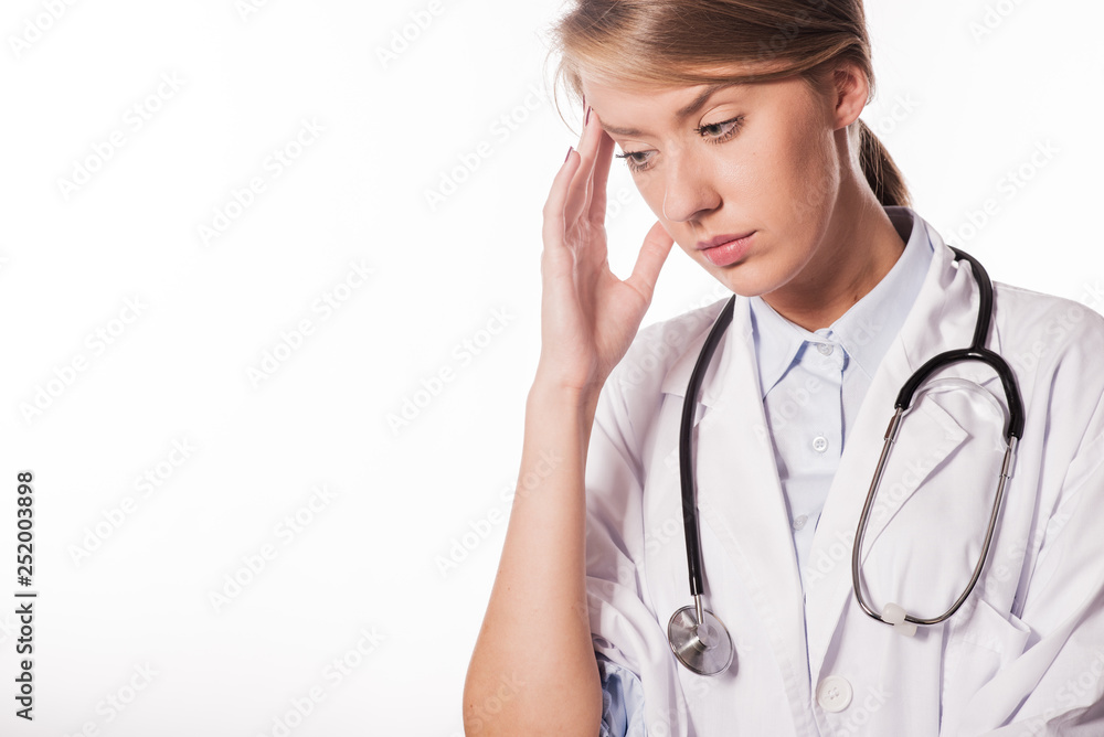 Woman doctor with migraine headache overworked and stressed. Woman doctor with migraine headache overworked and stressed.