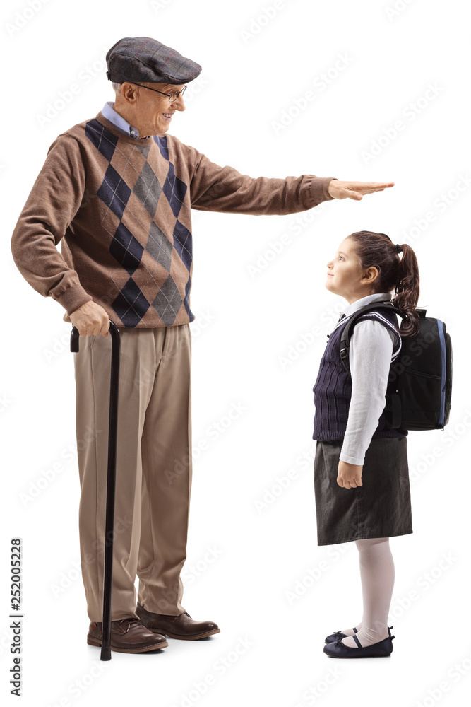 Grandfather gesturing with hand and showing the height of his granddaughter Grandfather gesturing with hand and showing the height of his granddaughter