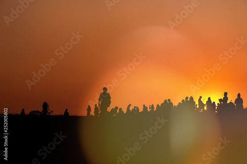 silhouettes of people taking pictures with smartphone