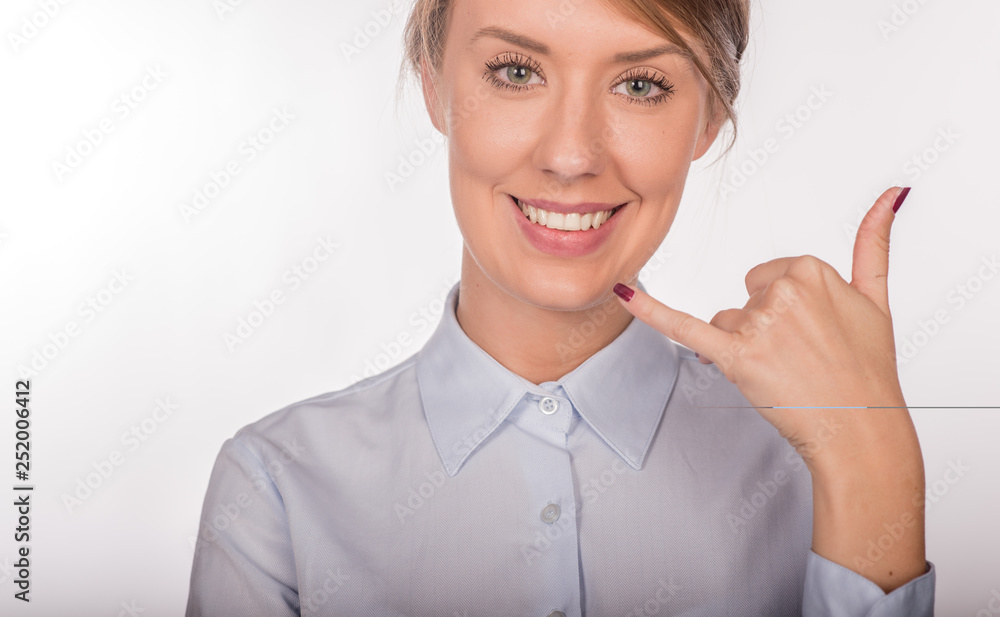 Pretty young woman gesturing a phone call. In white background Pretty young woman gesturing a phone call. In white background