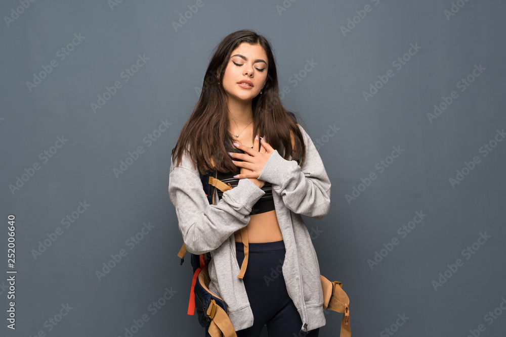 Teenager traveler girl over wall having a pain in the heart Teenager traveler girl over wall having a pain in the heart