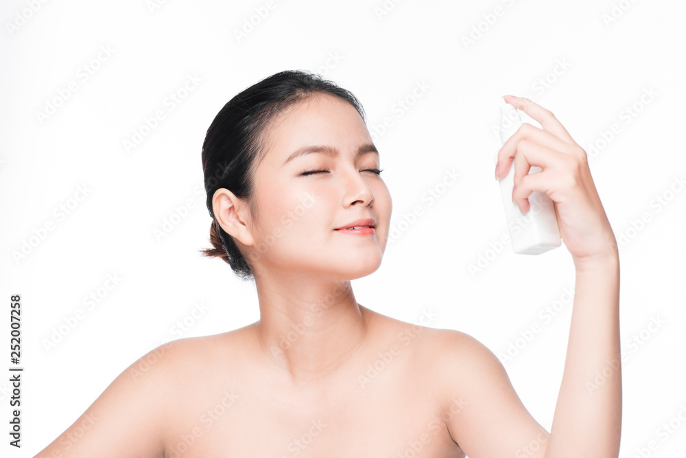 Beautiful asian woman holding spray water bottle isolated white background.