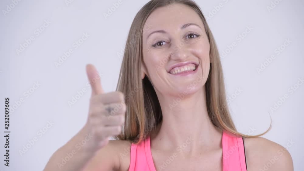 Face of happy blonde woman giving thumbs up Face of happy blonde woman giving thumbs up