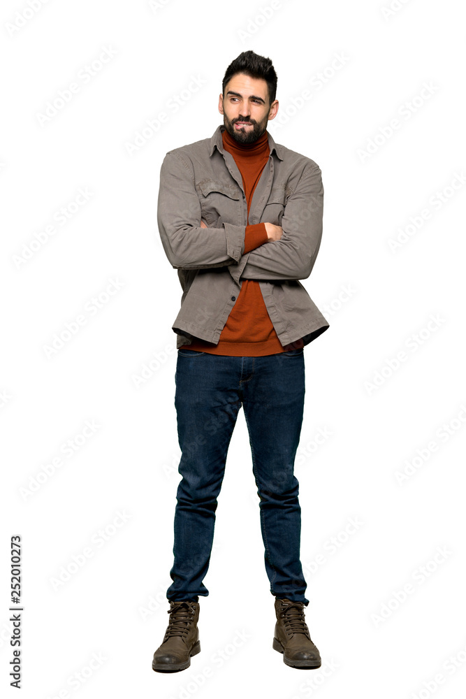 Full-length shot of Handsome man with beard with confuse face expression while bites lip on isolated white background Full-length shot of Handsome man with beard with confuse face expression while bites lip on isolated white background