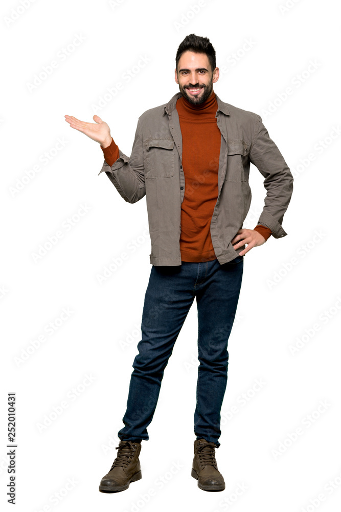 Full-length shot of Handsome man with beard holding copyspace imaginary on the palm to insert an ad on isolated white background Full-length shot of Handsome man with beard holding copyspace imaginary on the palm to insert an ad on isolated white background