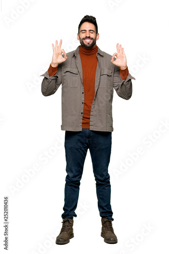 Full-length shot of Handsome man with beard in zen pose on isolated white background