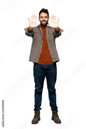 Full-length shot of Handsome man with beard counting ten with fingers on isolated white background
