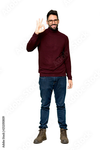 Full-length shot of Handsome man with glasses showing an ok sign with fingers on isolated white background
