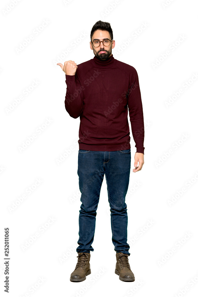Full-length shot of Handsome man with glasses unhappy and pointing to the side on isolated white background Full-length shot of Handsome man with glasses unhappy and pointing to the side on isolated white background
