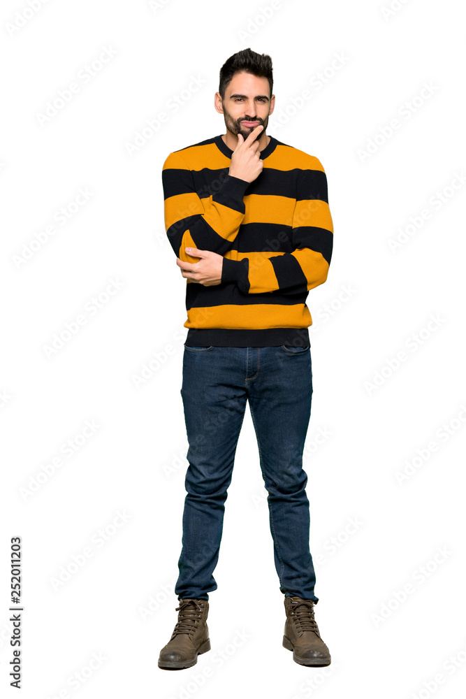 Full-length shot of Handsome man with striped sweater smiling and looking to the front with confident face on isolated white background Full-length shot of Handsome man with striped sweater smiling and looking to the front with confident face on isolated white background