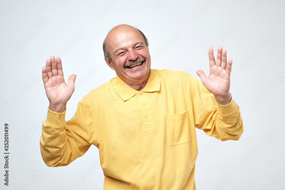 Portrait of senior happy man with hands lifted upwards Portrait of senior happy man with hands lifted upwards