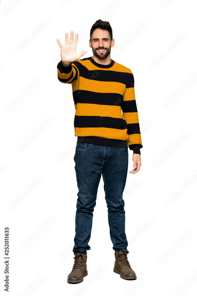 Full-length shot of Handsome man with striped sweater counting five with fingers on isolated white background Full-length shot of Handsome man with striped sweater counting five with fingers on isolated white background