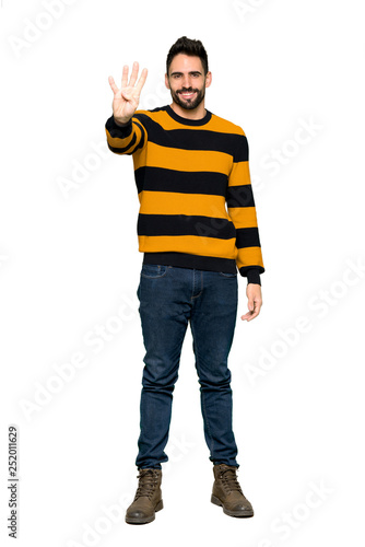 Full-length shot of Handsome man with striped sweater happy and counting four with fingers on isolated white background