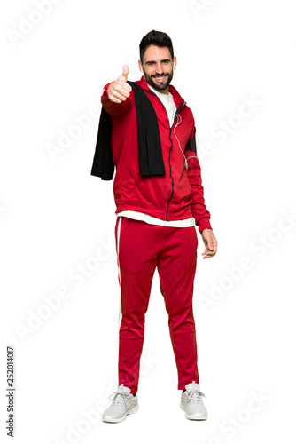 Full-length shot of Handsome sportman giving a thumbs up gesture because something good has happened on isolated white background