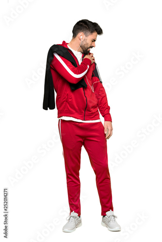 Full-length shot of Handsome sportman suffering from pain in shoulder for having made an effort on isolated white background