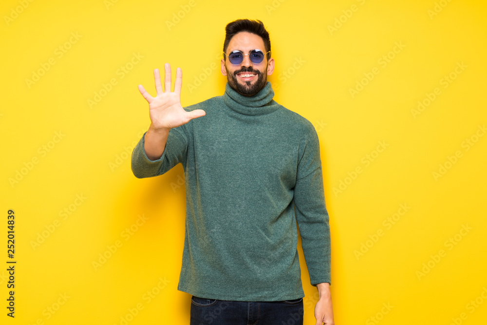 Handsome man with sunglasses counting five with fingers Handsome man with sunglasses counting five with fingers
