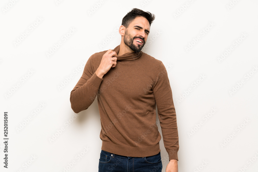 Fototapeta premium Handsome man over white wall with tired and sick expression