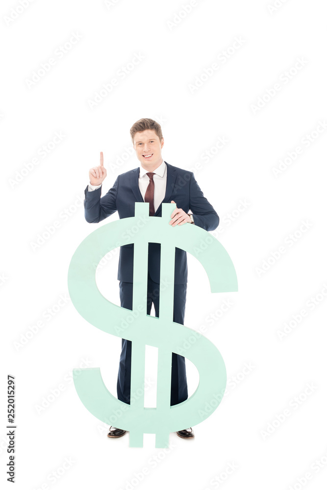 young smiling businessman with idea pointing up and posing with big dollar sign isolated on white young smiling businessman with idea pointing up and posing with big dollar sign isolated on white
