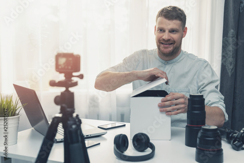 social media technology influencer recording unboxing video at home photo