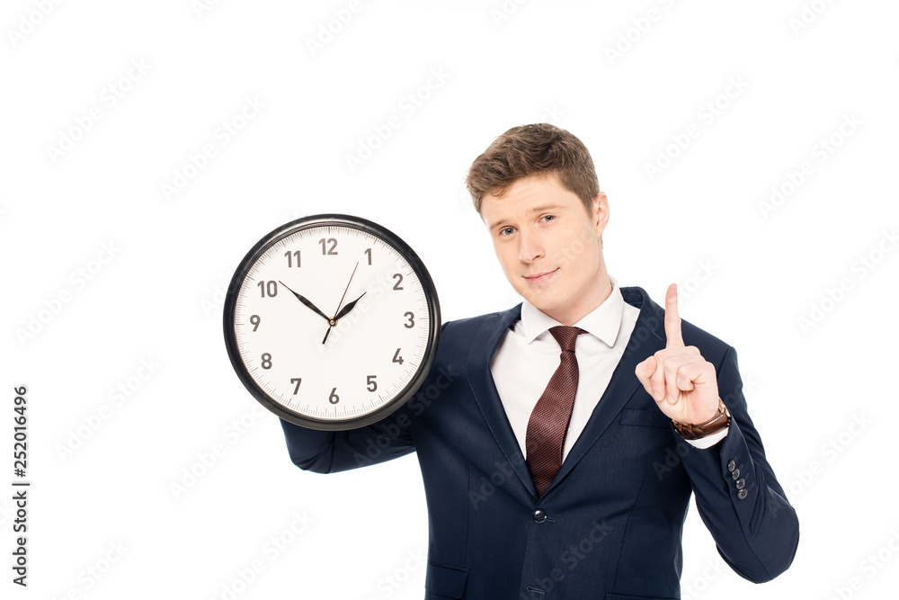 handsome businessman having idea and pointing up while holding clock isolated on white handsome businessman having idea and pointing up while holding clock isolated on white