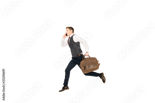 hurry businessman running with bag while talking on smartphone isolated on white © LIGHTFIELD STUDIOS