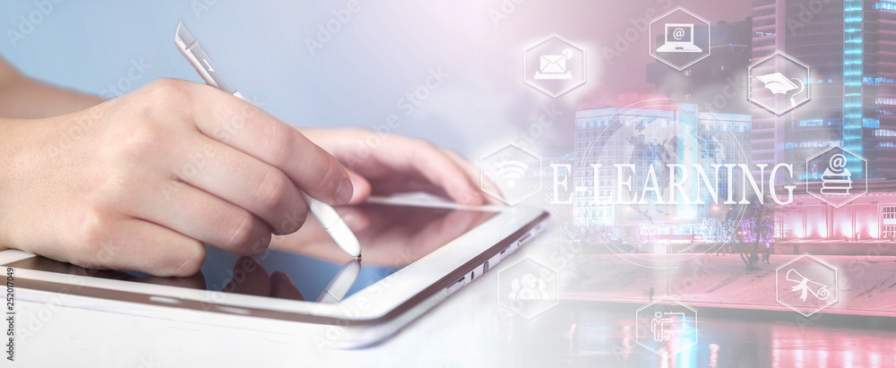 E-learning concept with a young man holding his tablet computer close-up over city background. E-learning concept with a young man holding his tablet computer close-up over city background.