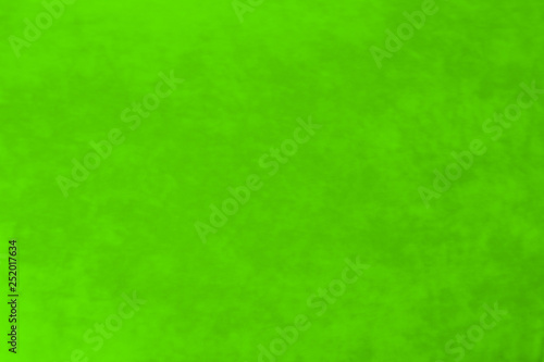 It is a background of fabric of green color of non-uniform texture.