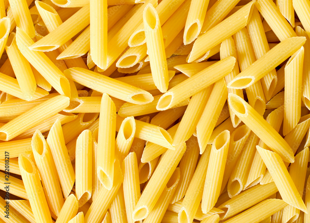 Delicious pasta, penne noodles background. Top view scene, healthy eating or healthy lifestyle. Penne pasta or macaroni, italian cuisine. Delicious pasta, penne noodles background. Top view scene, healthy eating or healthy lifestyle. Penne pasta or macaroni, italian cuisine.