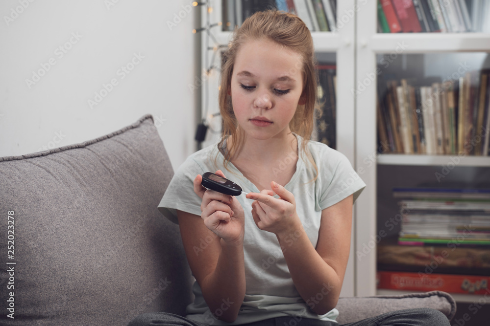 diabetic girl checking blood sugar level