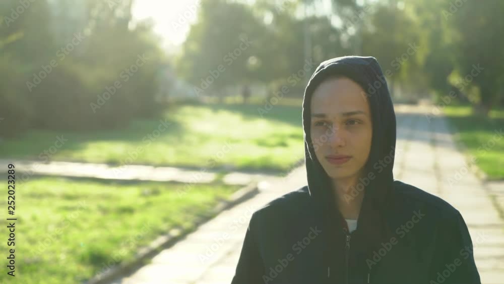 guy in the hood standing in the park in the morning, 4k guy in the hood standing in the park in the morning, 4k
