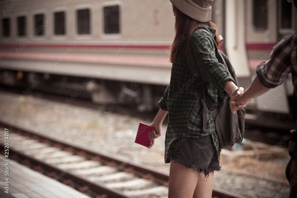 Fototapeta premium Happy young couple on railway station platform