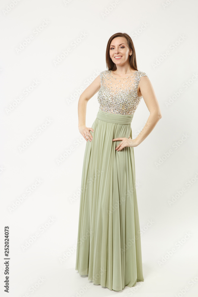 Full length photo of fashion model woman wearing elegant evening dress gown posing isolated on white wall background studio portrait. Brunette long hair girl. Mock up copy space. Olive dress face view