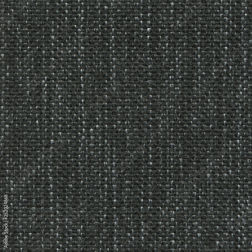 Black denim textile textured background. Vintage jeanse fashion background for designers and composing collages. Luxury textured genuine fabric of high and natural quality.