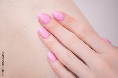 Female hand with pink manicure. Close-up. Manicure salon